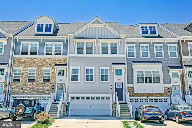 35290 Wright Way, Millsboro, DE 19966 - townhome / multi-family property with concrete driveway, an attached garage, stone siding, and board and batten siding