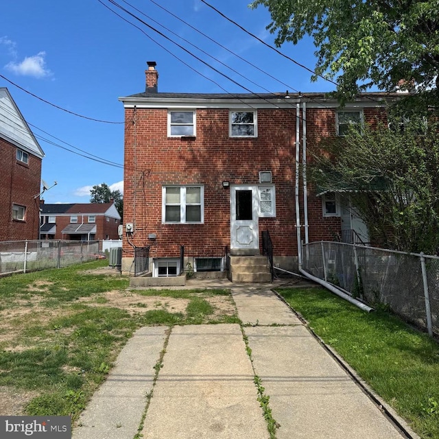 8024 Kimberly Rd, Dundalk, MD 21222 - rear view of property featuring a chimney, brick siding, and entry steps
