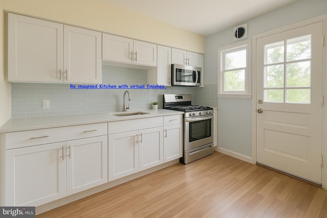 8024 Kimberly Rd, Dundalk, MD 21222 - kitchen with appliances with stainless steel finishes, a sink, light wood finished floors, and light countertops