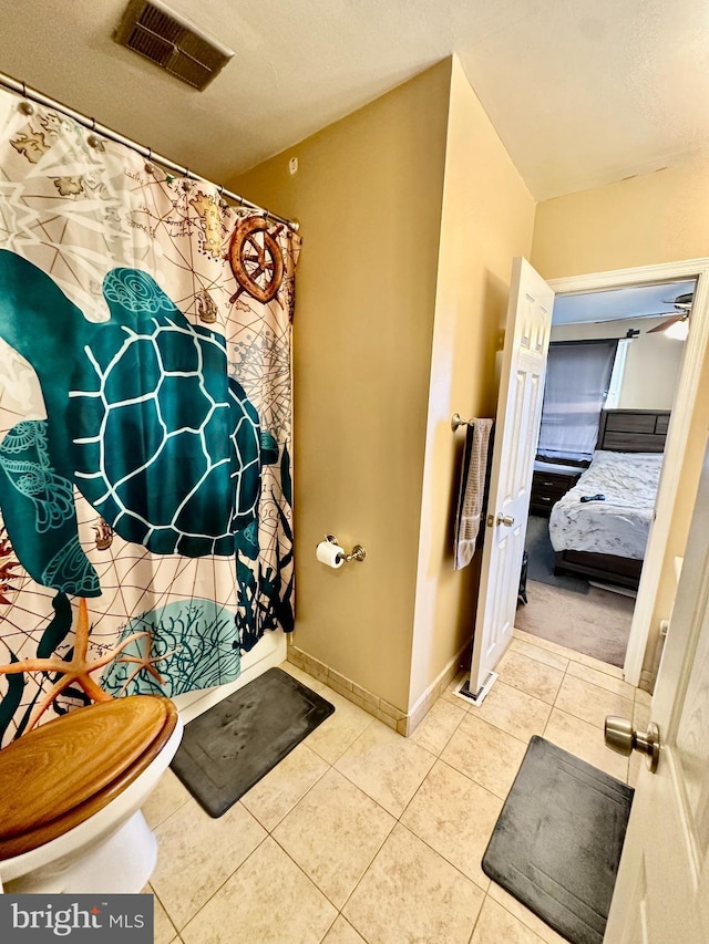 230 W Federal St, Burlington, NJ 08016 - ensuite bathroom featuring tile patterned floors, baseboards, toilet, and a shower with shower curtain