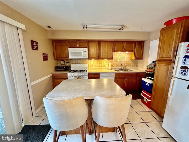 230 W Federal St, Burlington, NJ 08016 - kitchen featuring white appliances, decorative backsplash, a center island, light countertops, and a sink