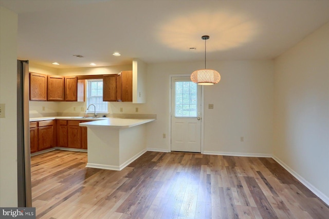 205 Saddle Ridge Dr, Harrisburg, PA 17110 - kitchen with a sink, a peninsula, healthy amount of natural light, light wood finished floors, and recessed lighting
