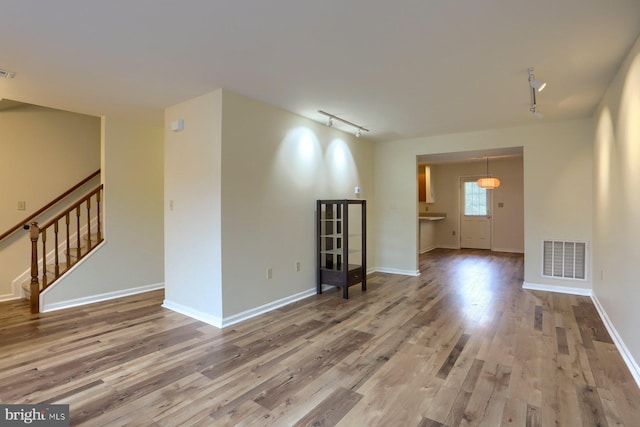205 Saddle Ridge Dr, Harrisburg, PA 17110 - unfurnished room featuring rail lighting, wood finished floors, stairs, and baseboards