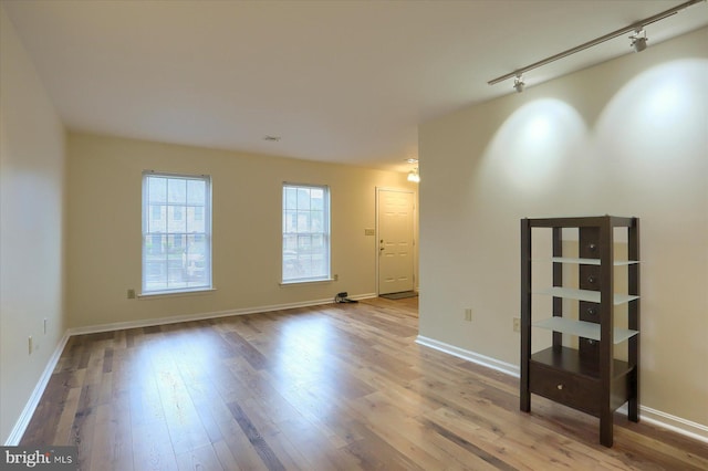 205 Saddle Ridge Dr, Harrisburg, PA 17110 - empty room with wood finished floors, track lighting, and baseboards