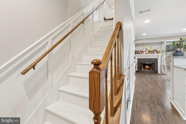 71 Sudbury Sq, Sterling, VA 20164 - staircase with wood finished floors, a warm lit fireplace, recessed lighting, and ornamental molding