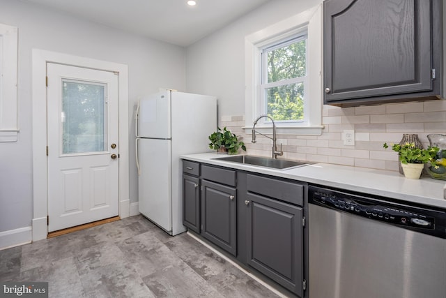 3023 Chesley, Baltimore, MD 21234 - kitchen with stainless steel dishwasher, a sink, freestanding refrigerator, gray cabinetry, and tasteful backsplash