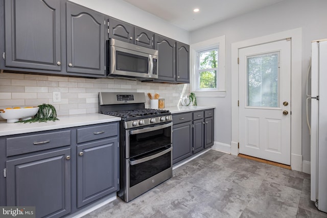 3023 Chesley, Baltimore, MD 21234 - kitchen with appliances with stainless steel finishes, backsplash, light countertops, gray cabinetry, and baseboards