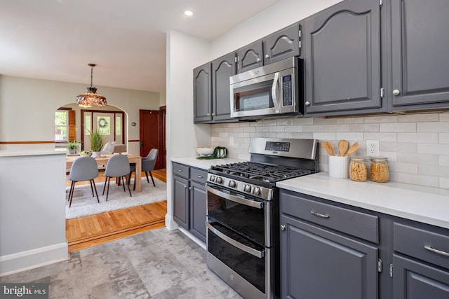 3023 Chesley, Baltimore, MD 21234 - kitchen with appliances with stainless steel finishes, arched walkways, tasteful backsplash, gray cabinets, and light countertops