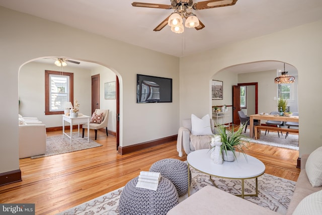 3023 Chesley, Baltimore, MD 21234 - living area with arched walkways, a ceiling fan, light wood-style floors, and baseboards