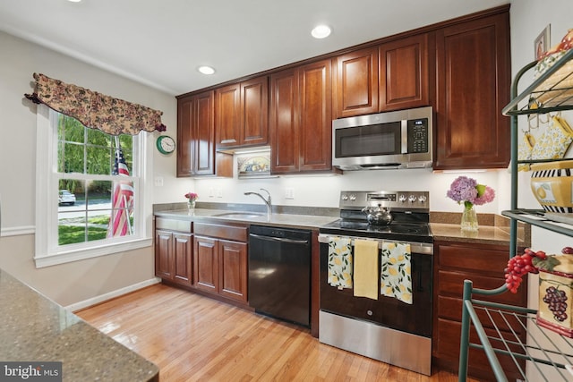 6090 Crown Royal Cir, Alexandria, VA 22310 - kitchen with stainless steel appliances, light wood-style flooring, recessed lighting, and dark stone countertops