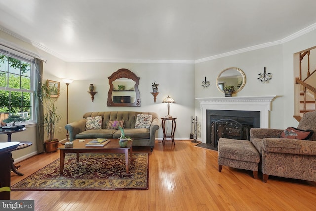 6090 Crown Royal Cir, Alexandria, VA 22310 - living area featuring hardwood / wood-style floors, ornamental molding, a fireplace with flush hearth, and stairway