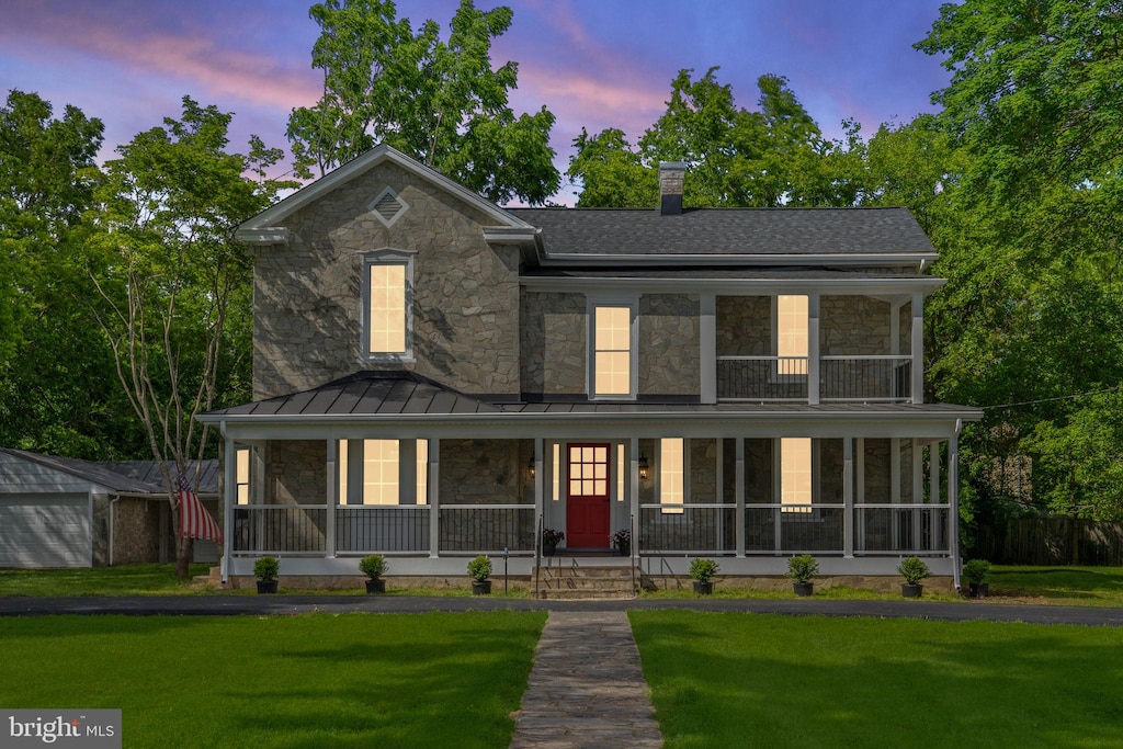 105 E Washington St, Remington, VA 22734 - view of front of property with stone siding, a standing seam roof, and a lawn