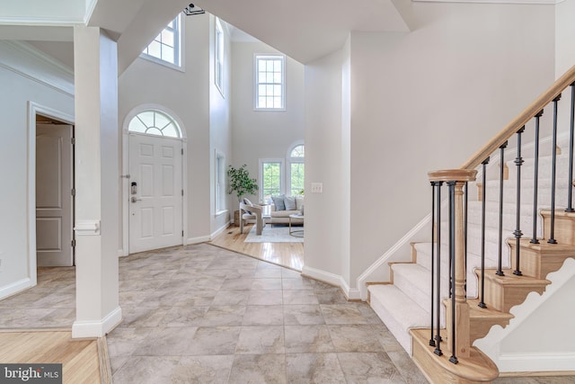 42720 Mount Auburn Pl, Broadlands, VA 20148 - entrance foyer featuring stairway, a towering ceiling, and baseboards