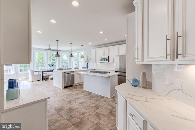 42720 Mount Auburn Pl, Broadlands, VA 20148 - kitchen with appliances with stainless steel finishes, decorative backsplash, a peninsula, recessed lighting, and white cabinets