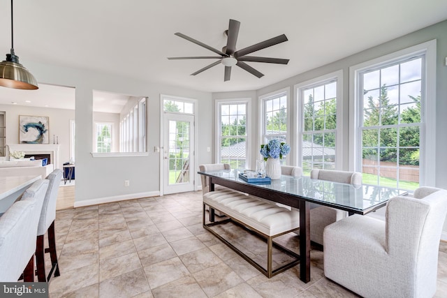42720 Mount Auburn Pl, Broadlands, VA 20148 - dining area with a ceiling fan, baseboards, and a fireplace
