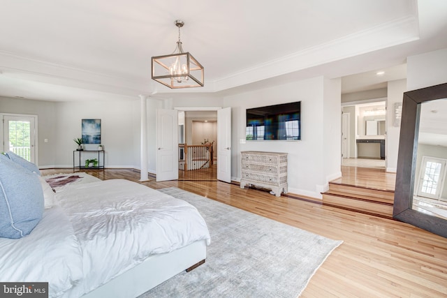 42720 Mount Auburn Pl, Broadlands, VA 20148 - bedroom with multiple windows, ornamental molding, a chandelier, wood finished floors, and baseboards