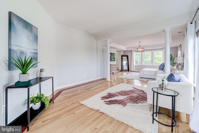 42720 Mount Auburn Pl, Broadlands, VA 20148 - living area with ornate columns, wood finished floors, and baseboards
