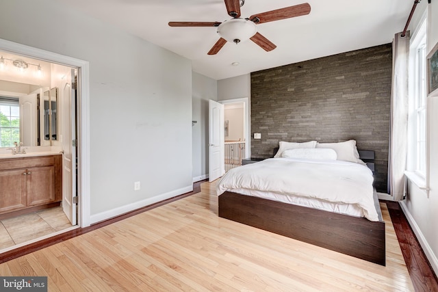 42720 Mount Auburn Pl, Broadlands, VA 20148 - bedroom with light wood-style flooring, a sink, ensuite bath, and baseboards