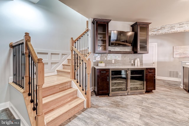 42720 Mount Auburn Pl, Broadlands, VA 20148 - bar area featuring wine cooler, backsplash, light wood-type flooring, and baseboards