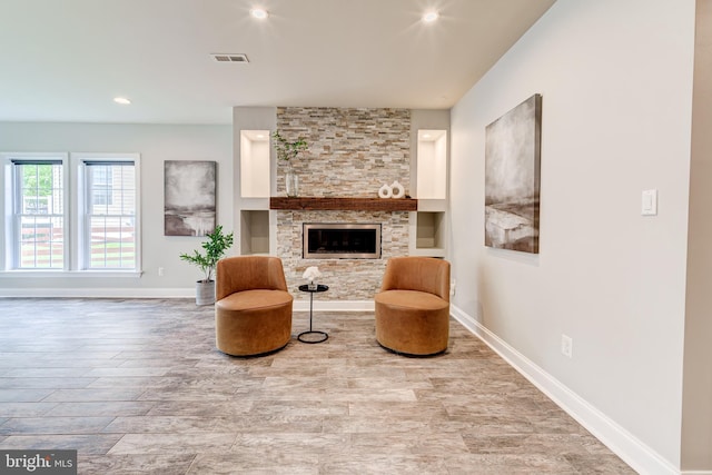 42720 Mount Auburn Pl, Broadlands, VA 20148 - living area featuring wood finished floors, baseboards, a stone fireplace, and recessed lighting
