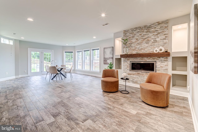 42720 Mount Auburn Pl, Broadlands, VA 20148 - living room with wood finished floors, baseboards, recessed lighting, and a stone fireplace