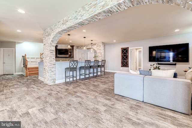 42720 Mount Auburn Pl, Broadlands, VA 20148 - living room with arched walkways, baseboards, wood finished floors, and recessed lighting