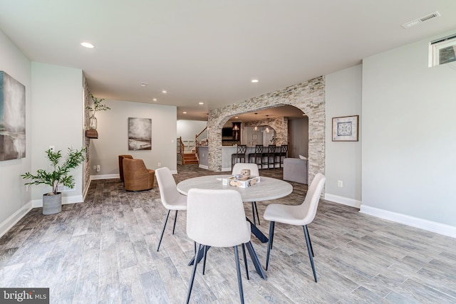 42720 Mount Auburn Pl, Broadlands, VA 20148 - dining space featuring arched walkways, wood finished floors, baseboards, and recessed lighting