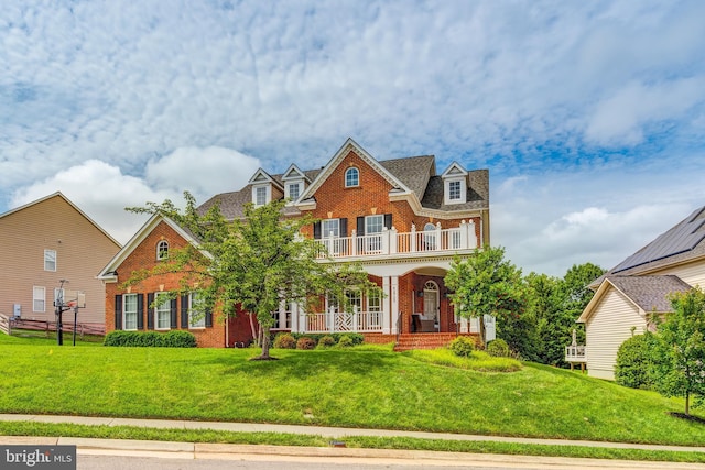 42720 Mount Auburn Pl, Broadlands, VA 20148 - colonial-style house featuring brick siding, a balcony, a porch, and a front lawn