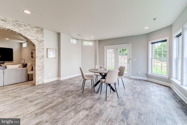 42720 Mount Auburn Pl, Broadlands, VA 20148 - dining area featuring wood finished floors, arched walkways, recessed lighting, and baseboards