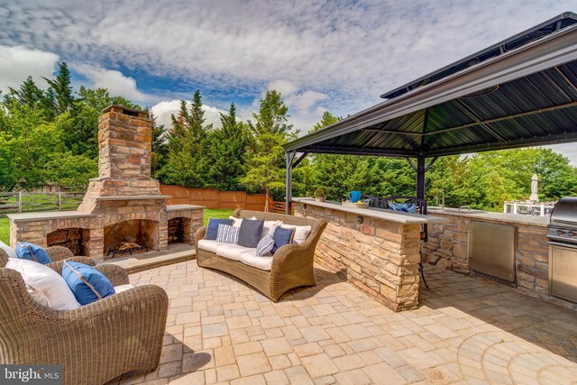 42720 Mount Auburn Pl, Broadlands, VA 20148 - view of patio / terrace featuring an outdoor living space with a fireplace, exterior kitchen, and a gazebo