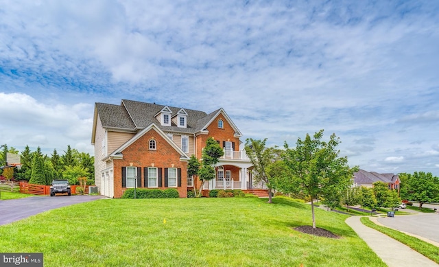 42720 Mount Auburn Pl, Broadlands, VA 20148 - view of front facade featuring brick siding, a porch, a front yard, and driveway