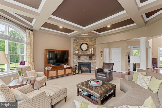 22415 Conservancy Dr, Ashburn, VA 20148 - living room featuring coffered ceiling, a stone fireplace, healthy amount of natural light, beam ceiling, and decorative columns
