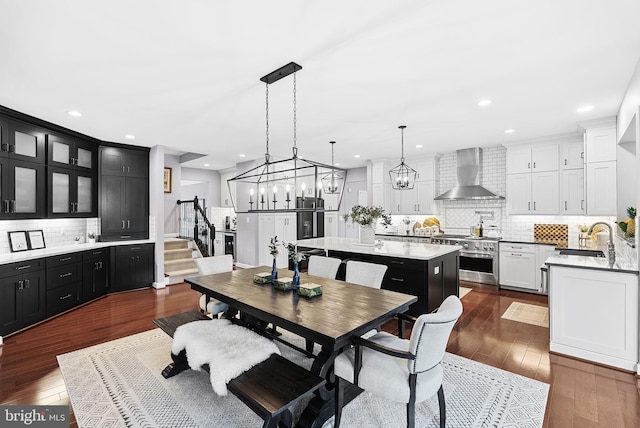22415 Conservancy Dr, Ashburn, VA 20148 - dining area featuring stairs, dark wood-style flooring, recessed lighting, and a chandelier
