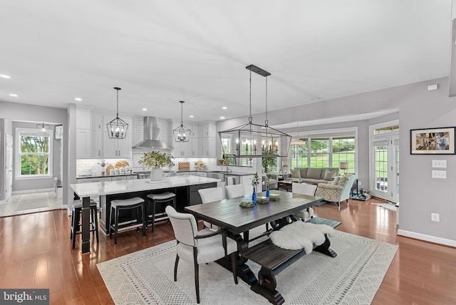 22415 Conservancy Dr, Ashburn, VA 20148 - dining space featuring baseboards, wood finished floors, recessed lighting, and a chandelier