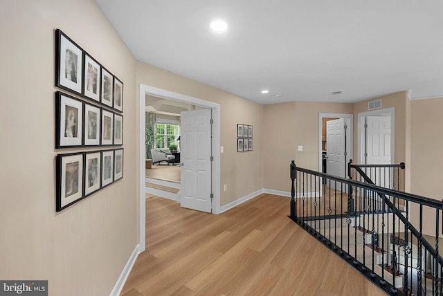 22415 Conservancy Dr, Ashburn, VA 20148 - corridor with an upstairs landing, baseboards, light wood-style flooring, and recessed lighting