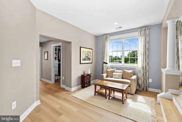22415 Conservancy Dr, Ashburn, VA 20148 - sitting room featuring ornate columns, light wood-style floors, and baseboards