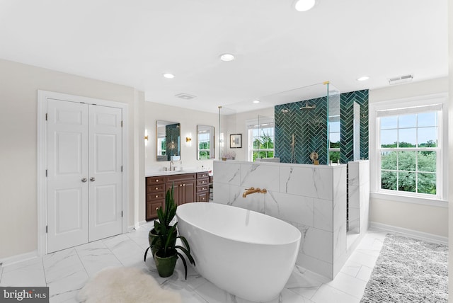 22415 Conservancy Dr, Ashburn, VA 20148 - full bath featuring vanity, a freestanding bath, baseboards, marble finish flooring, and recessed lighting