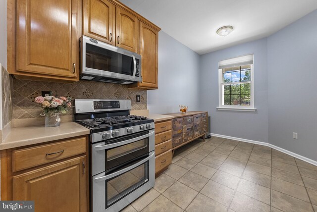 3 River Birch Cir, Princeton, NJ 08540 - kitchen featuring appliances with stainless steel finishes, backsplash, baseboards, light countertops, and brown cabinetry