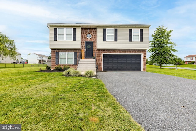 15245 Wedgewood Dr, Greencastle, PA 17225 - bi-level home with an attached garage, driveway, brick siding, and a front lawn