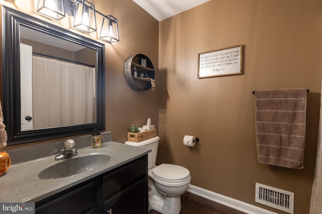 15245 Wedgewood Dr, Greencastle, PA 17225 - full bathroom with vanity, toilet, baseboards, and wood finished floors