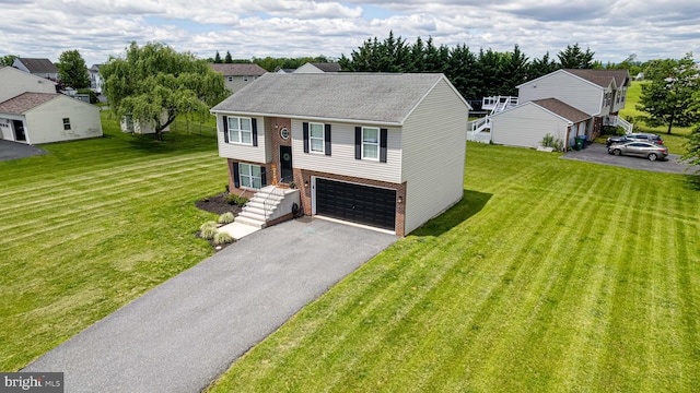 15245 Wedgewood Dr, Greencastle, PA 17225 - split foyer home featuring brick siding, asphalt driveway, an attached garage, and a front yard