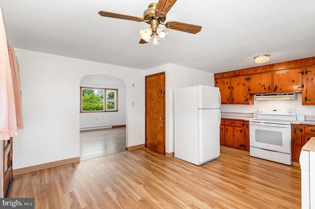 335 Bolton Ave, Carlisle, PA 17013 - kitchen featuring white appliances, under cabinet range hood, a baseboard radiator, brown cabinetry, and arched walkways