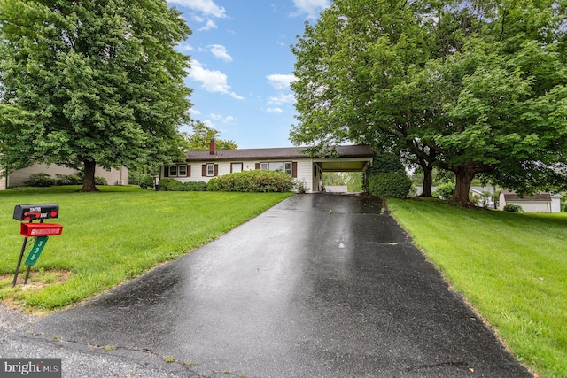 335 Bolton Ave, Carlisle, PA 17013 - single story home featuring driveway, a front yard, a chimney, and a carport