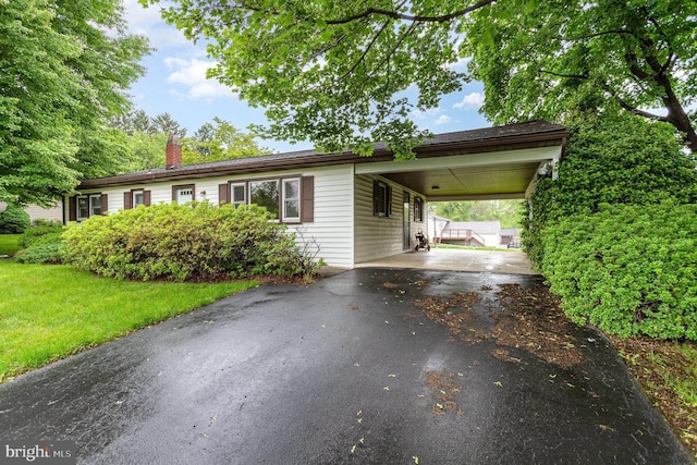 335 Bolton Ave, Carlisle, PA 17013 - single story home featuring a chimney, asphalt driveway, a carport, and a front lawn