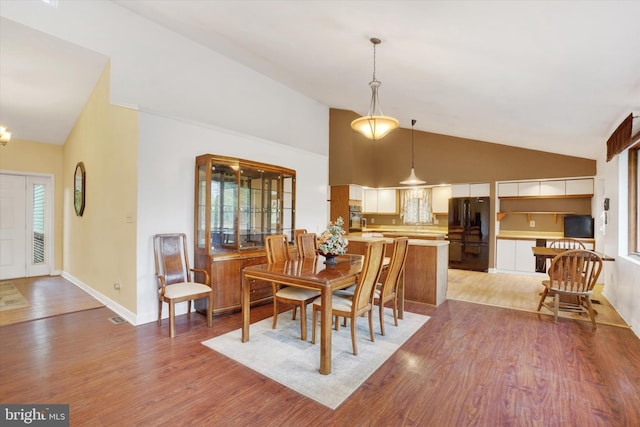 8292 Hickory Rd, Stewartstown, PA 17363 - dining room with lofted ceiling, light wood finished floors, and baseboards
