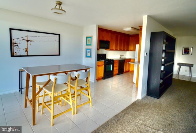 2401 Pennsylvania Ave Unit 6B29, Philadelphia, PA 19130 - kitchen with black appliances, light tile patterned flooring, and baseboards