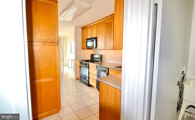 2401 Pennsylvania Ave Unit 6B29, Philadelphia, PA 19130 - kitchen featuring black microwave, range with gas stovetop, dishwashing machine, light tile patterned flooring, and backsplash
