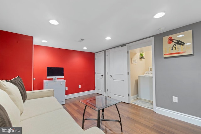 1317 Winston Ave, Baltimore, MD 21239 - living room with washer / clothes dryer, wood finished floors, and recessed lighting