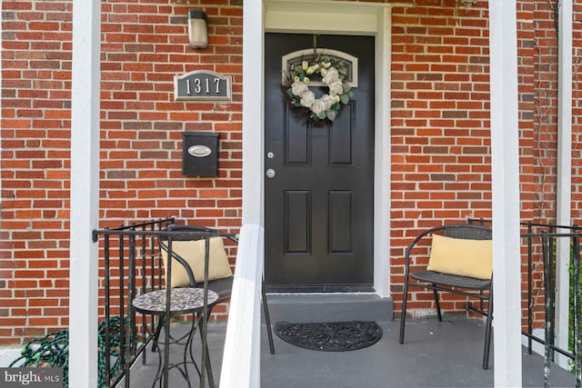 1317 Winston Ave, Baltimore, MD 21239 - property entrance featuring brick siding and a porch