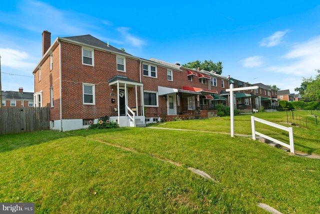 1317 Winston Ave, Baltimore, MD 21239 - townhome / multi-family property with a chimney, brick siding, and a residential view